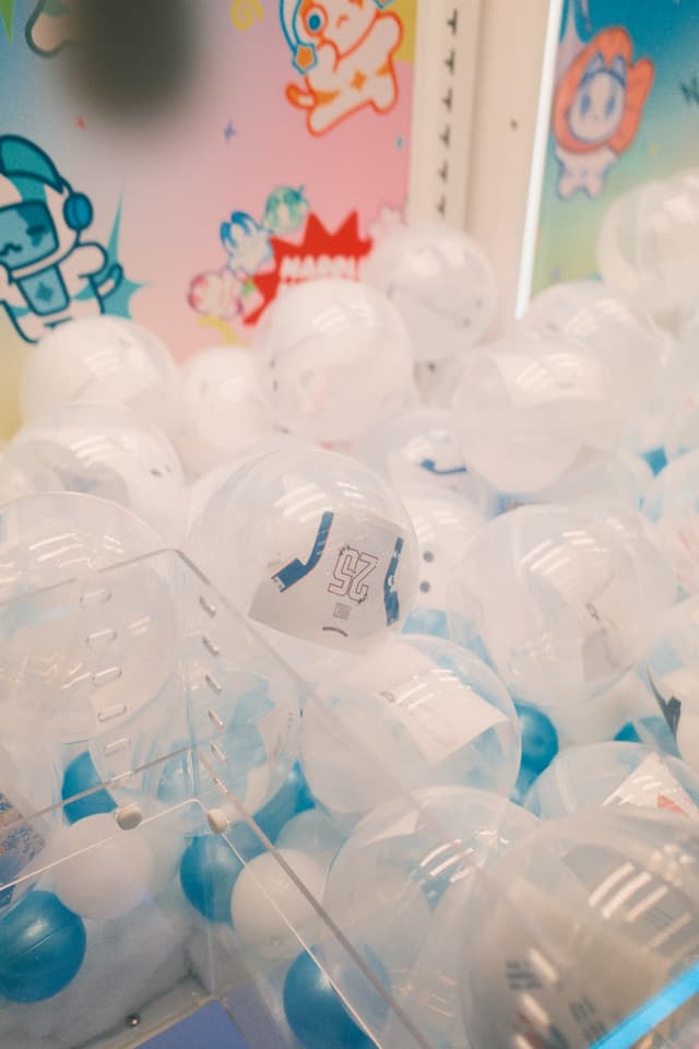 Capsules with mini jerseys sealed inside a custom branded Clawesome claw machine at Stay in Bloom festival