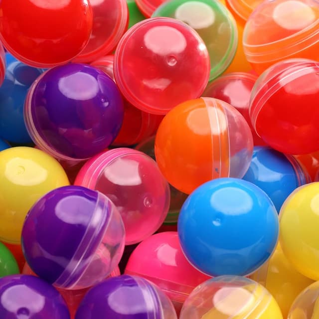 Colorful mini capsules used to hide claw machine tokens for an event scavenger hunt