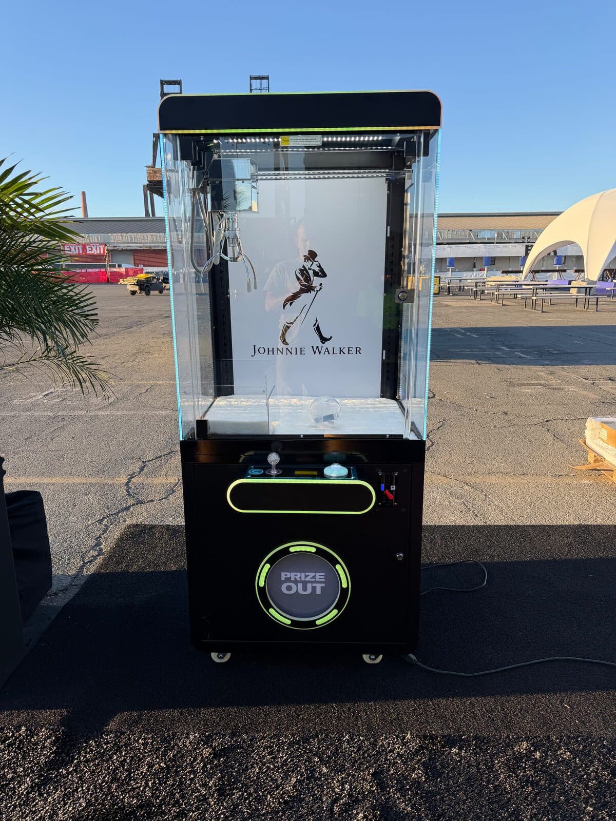 Johnnie Walker branded black claw machine set up outdoors on Pier 80 in San Francisco for Portola Music Festival 2026