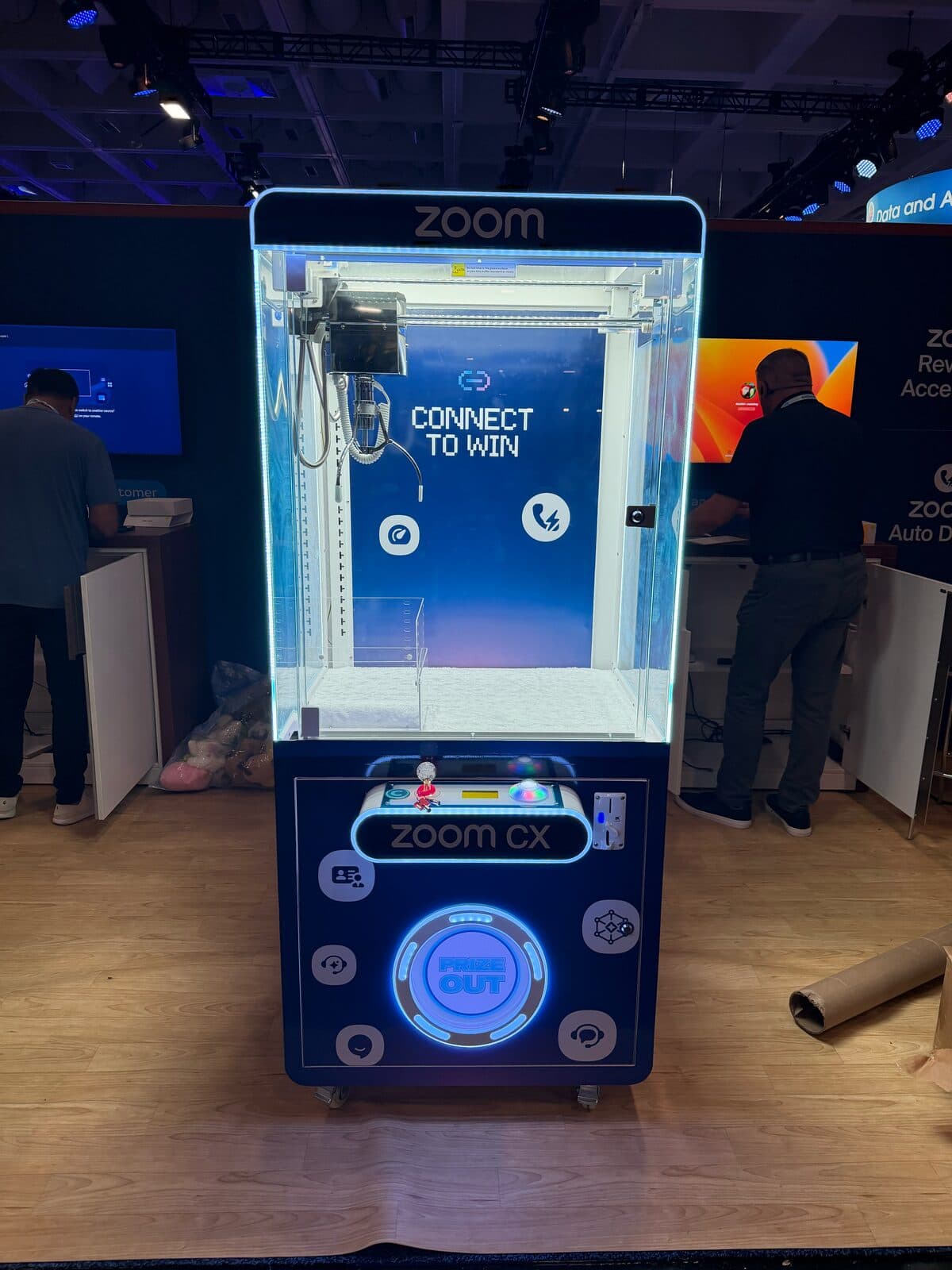 Zoom CX branded claw machine with Connect to Win backdrop at a conference booth